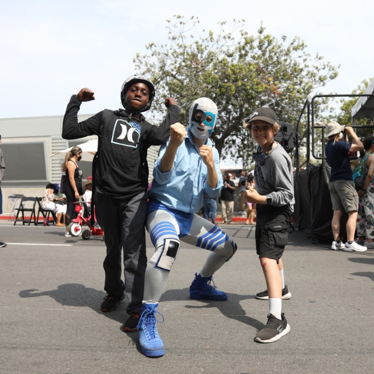 Lucha libre wrestler BART-Man poses with fans at BART’s 50th Anniversary Celebration and Family Fun Festival on Sept. 10, 2022.