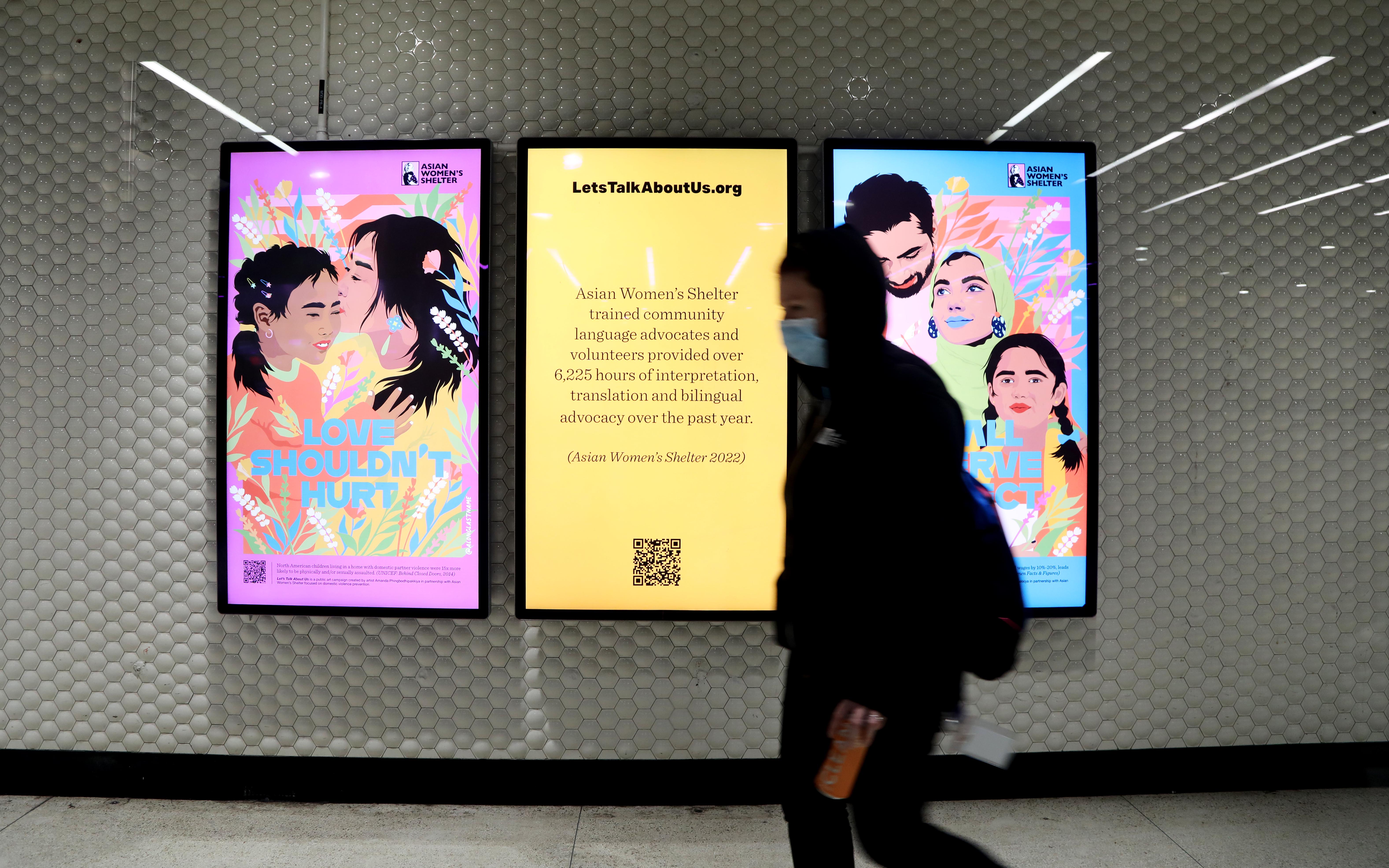 Let's Talk About Us posters on digital screens at Powell Station