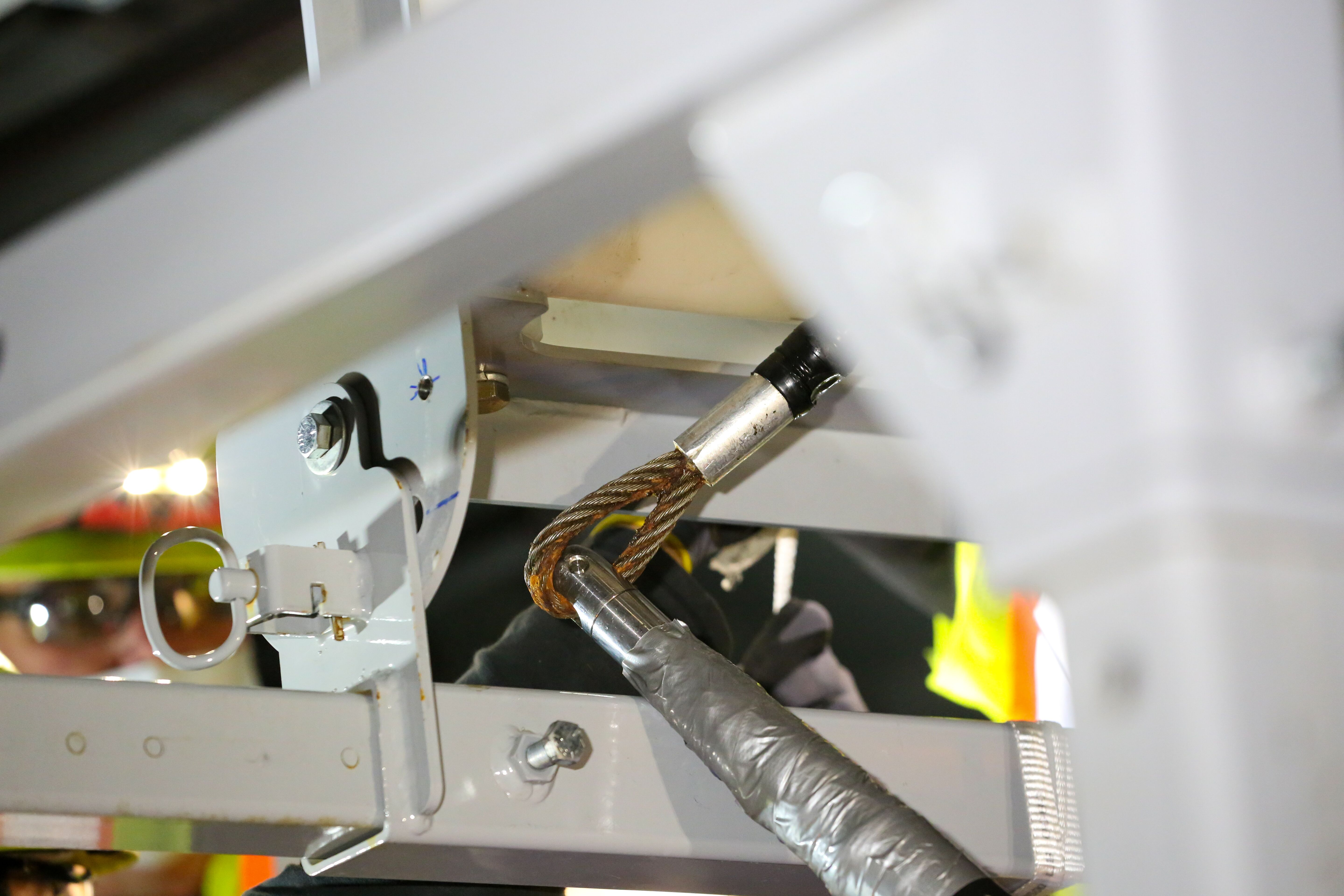 An electrician attaching the steel braided line to the start of the cable pull