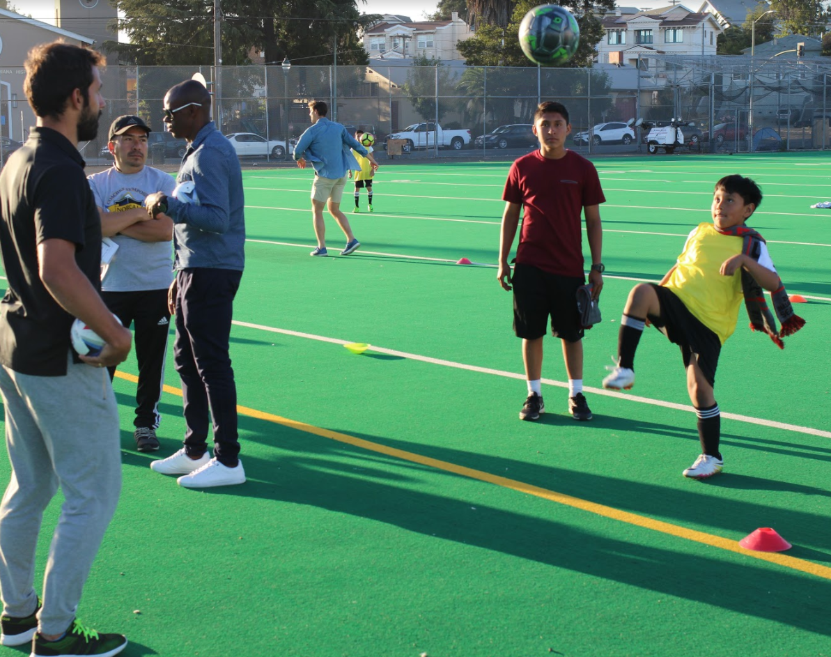 Isai kicks a soccer ball