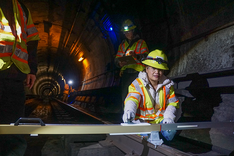 Senior Engineer Van Nguyen uses a gauge to measure fault creep in the BART Caldecott Tunnel