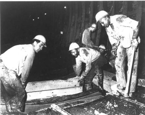 Circa 1960s: Workers laying track inside the Transbay Tube. 