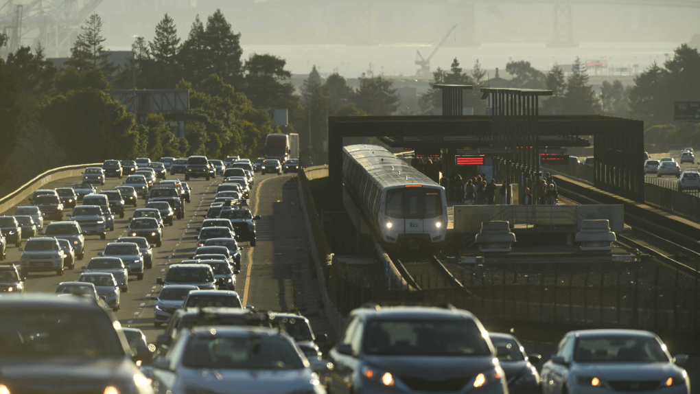 A BART train with car traffic.