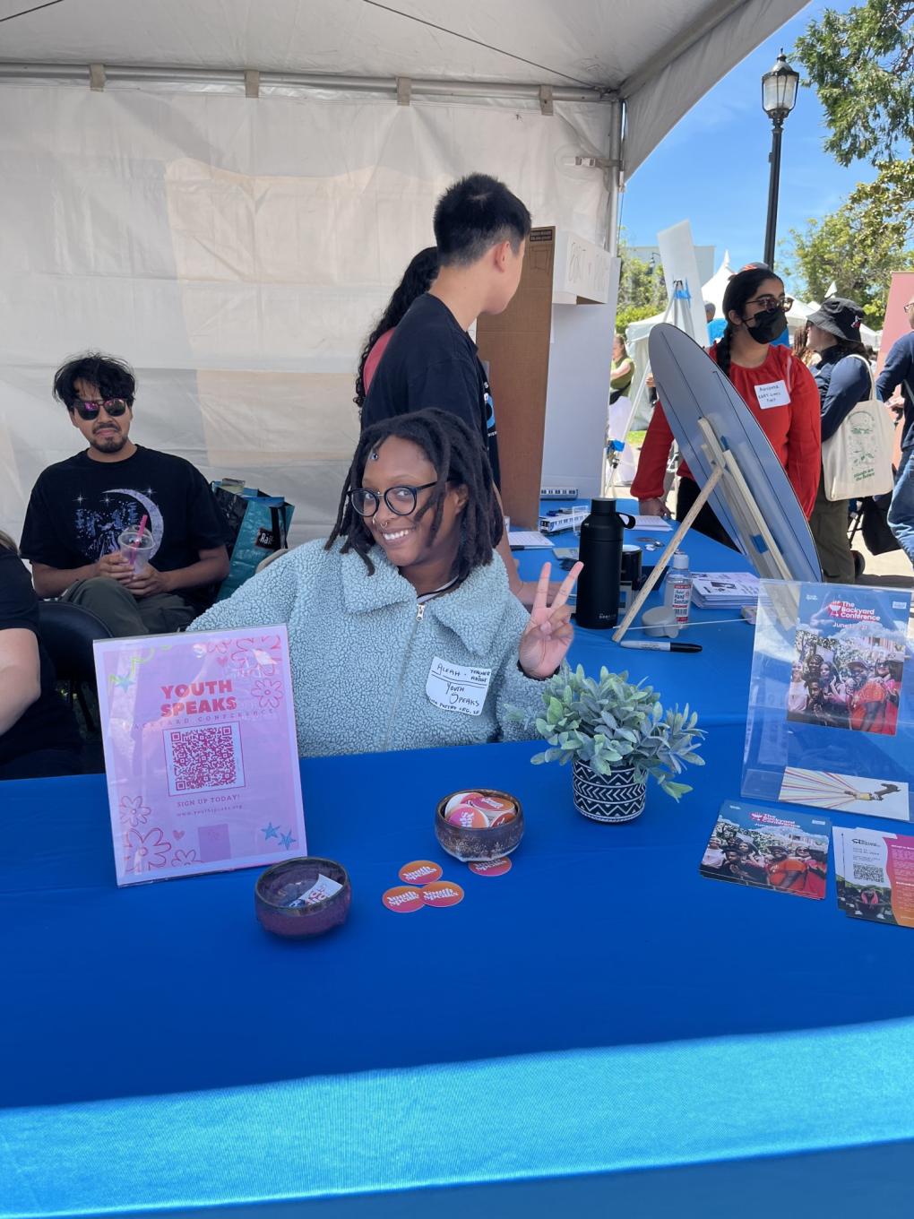 A person from Youth Speaks tabling with BART