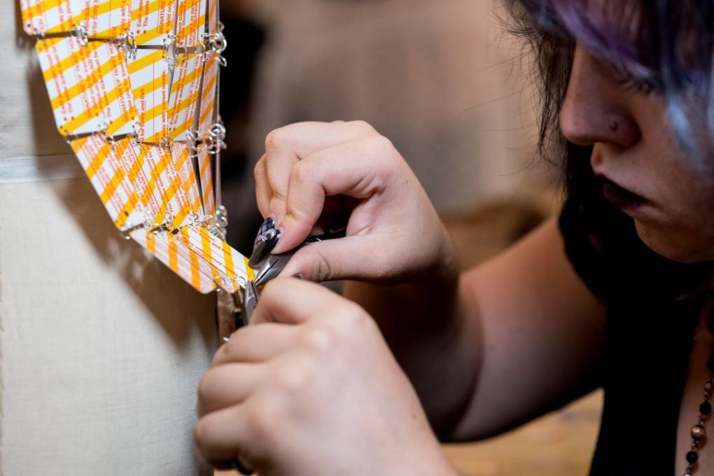 A person tinkering with a dress.