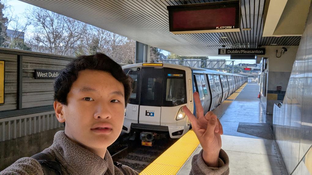 Enzo Wu poses on a BART platform